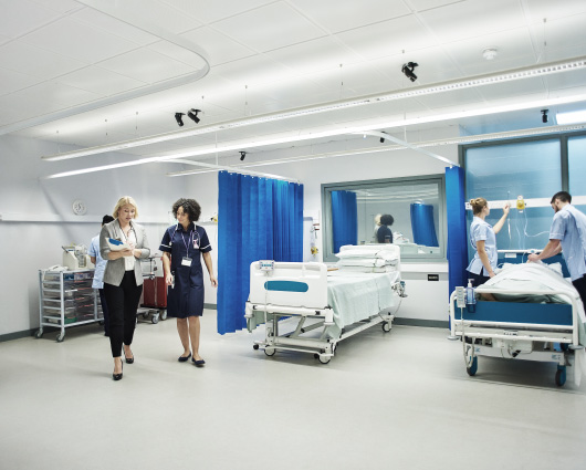 Healthcare professionals working within a clean and modern hospital ward